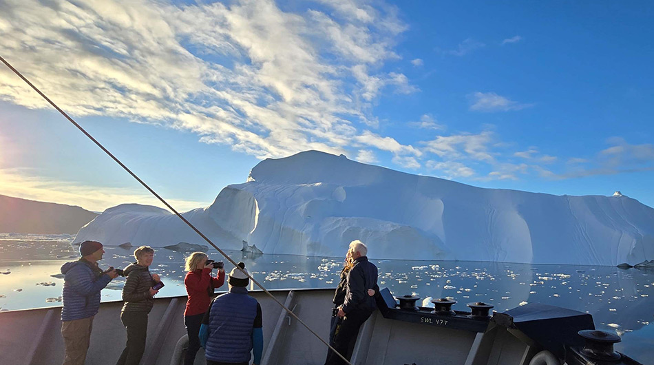 M/S Balto - guests on front deck of ship looking at Arctic ice M/S Balto - guests on front deck of ship looking at Arctic ice