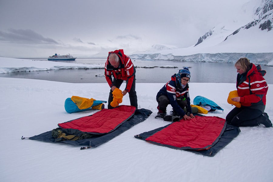 Campers lying out their sleeping bags