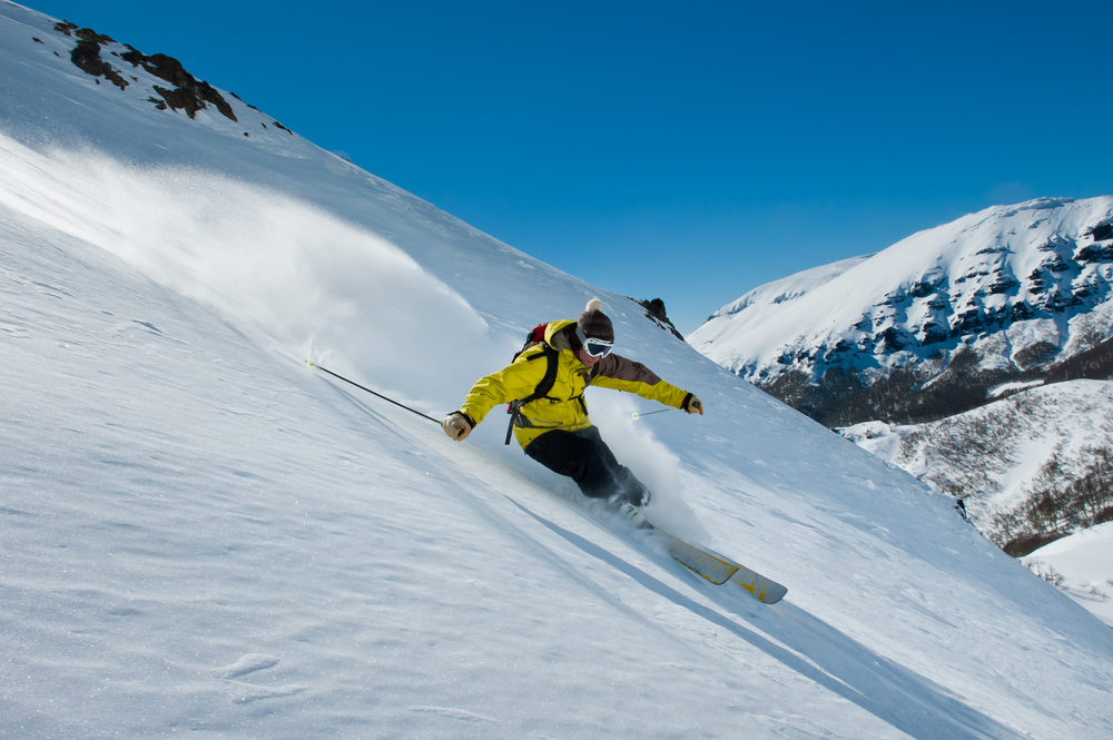 a guy skiing in the fresh snow in the mountains a guy skiing in the fresh snow in the mountains