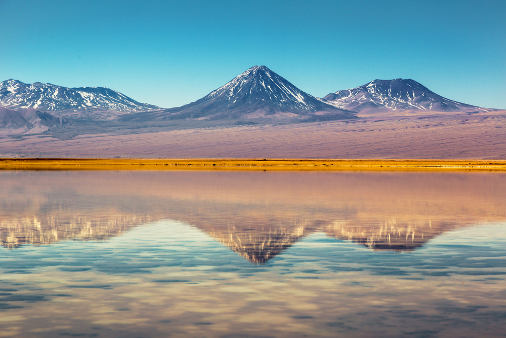 mountains with yellow in front and reflection in water atacama chile mountains with yellow in front and reflection in water atacama chile