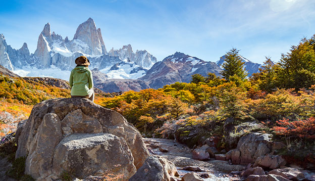 a hiker rests on a rock in Patagonia
