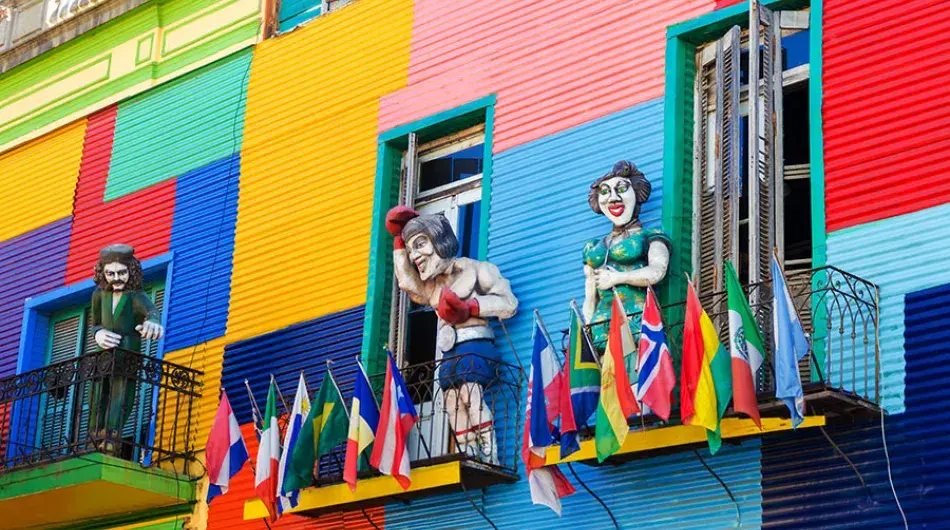 Multicolour house facade withe giant dolls on the balcony, Buenos Aires Argentina