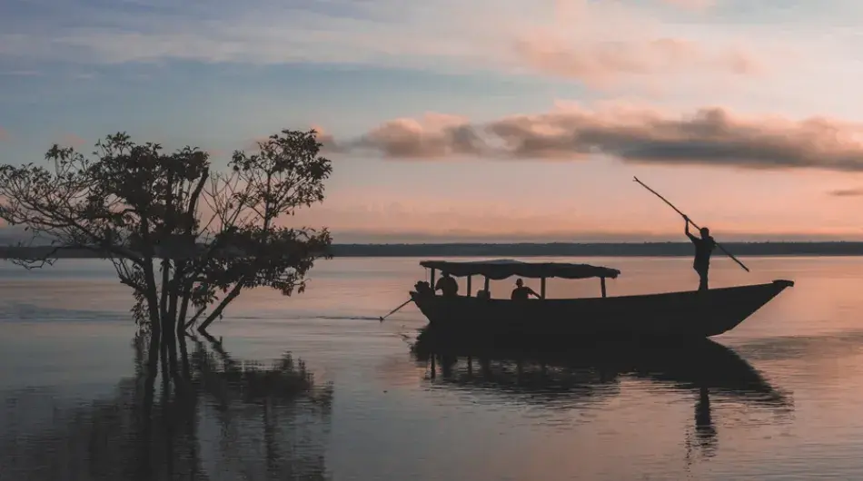Amazon fisherman at dusk on his boat
