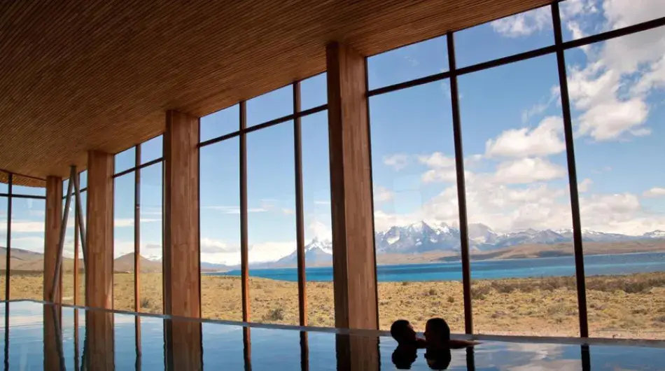 Tierra Patagonia Hotel infinity pool with view over torres del paine landscape