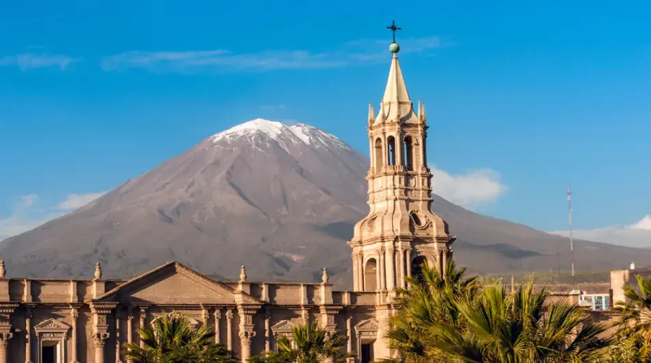 Arequipa basilica with misti volcano in background on blue sky