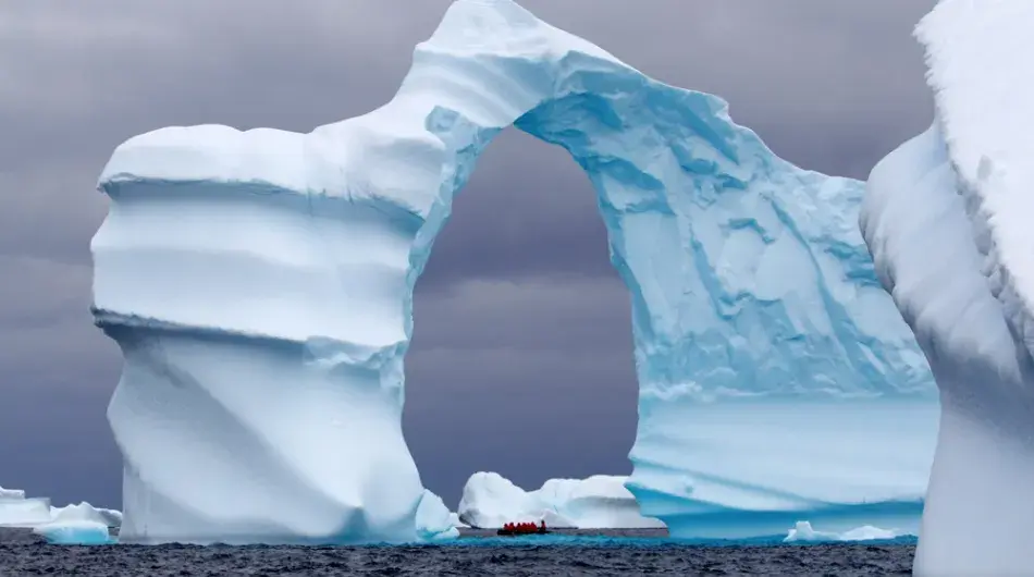 Beautiful blue arched iceberg in antarctica