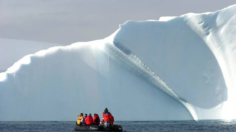 Zodiac in front of iceberg in Antarctica