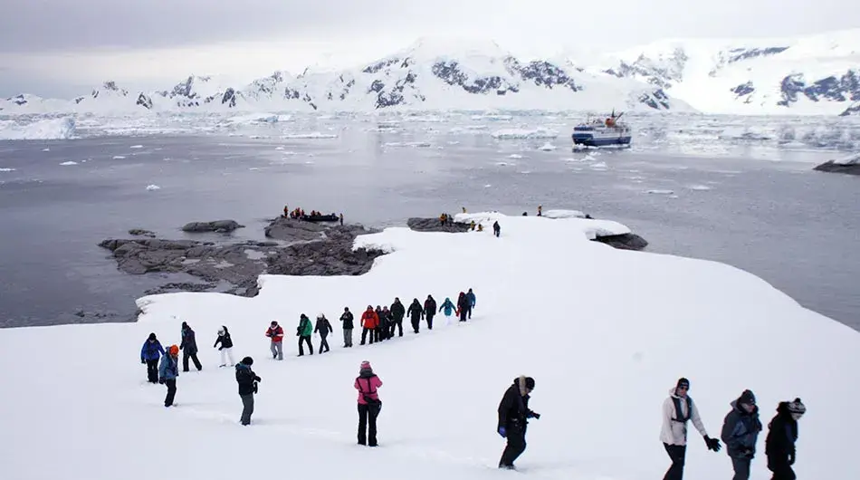 Ocean Nova in Antarctica with people at a landing