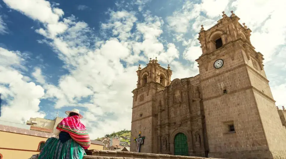 Puno main cathedral with peruvian woman