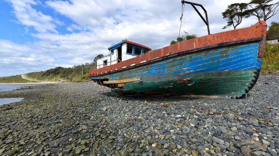 puerto williams, boat washed up on shore