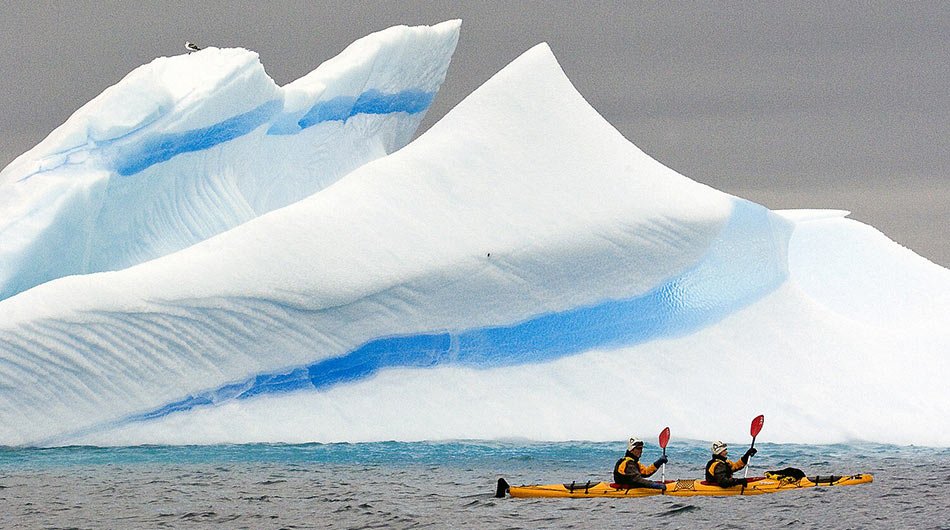 kayaking in front of iceberg Antarctica