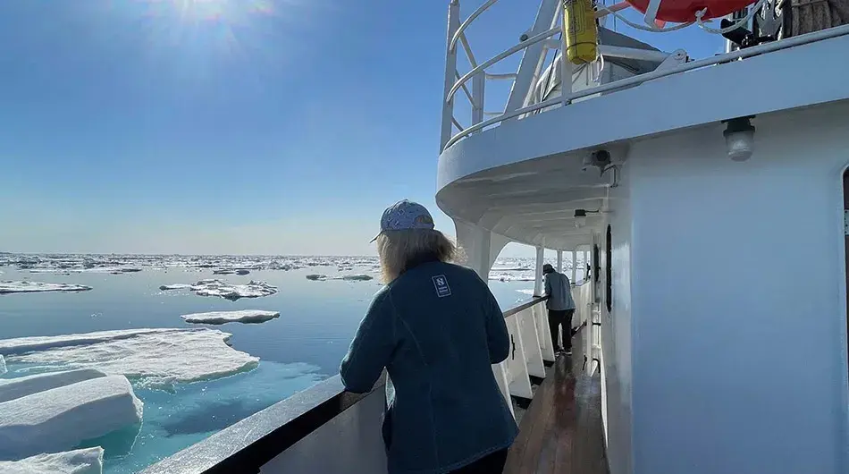 MS Sjoveien - Guest out on deck sailing in the Arctic 