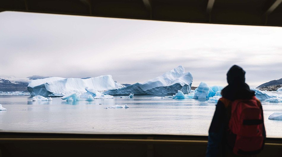 M/S Balto - guest looking out over the Arcitc landscapes from the yacht 