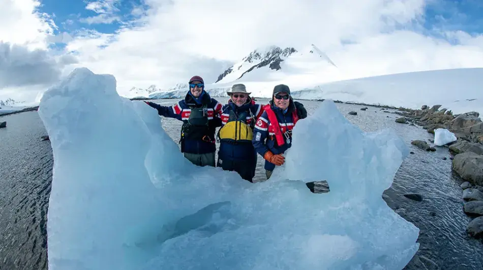 expedition cruise team and iceberg in Antarctica