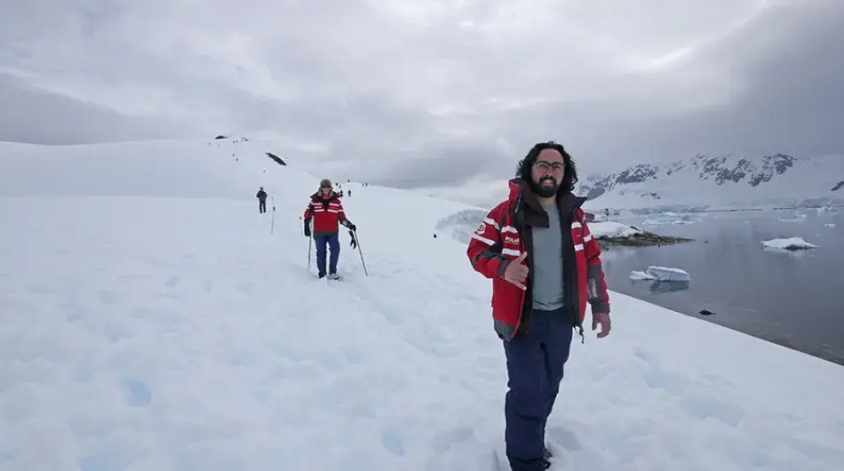 people hiking in Antarctica on the snow