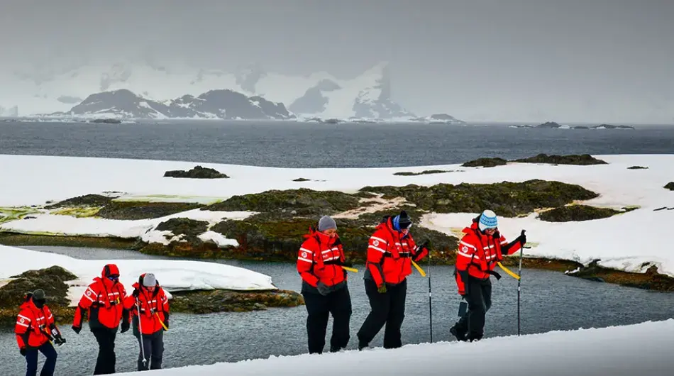 Expedition cruise guests hiking in the Yalour Islands, Antarctica