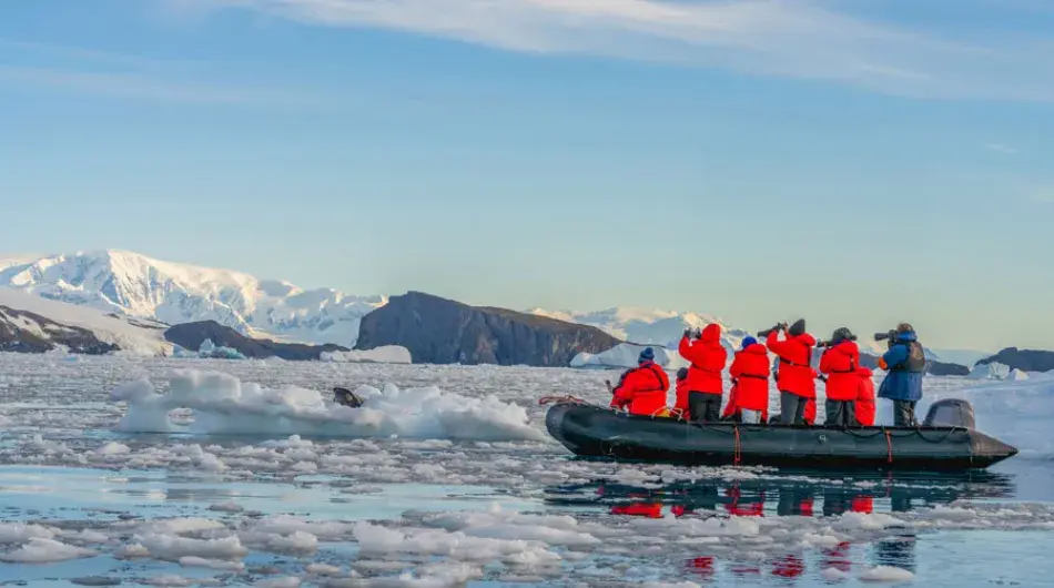 Tourists enjoying zodiac ride in Antarctica