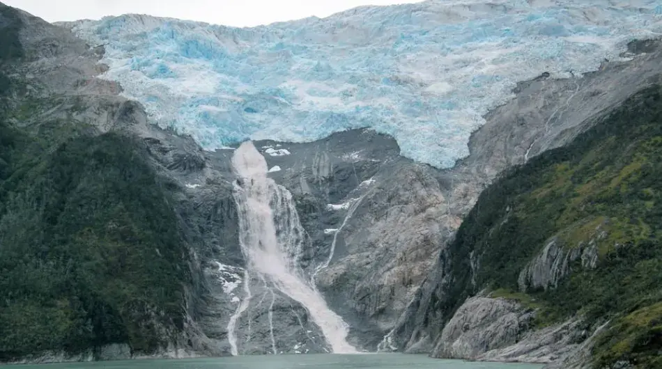 waterfall off the hanging glacier at Armiento Canal in Chilean Patagonia 