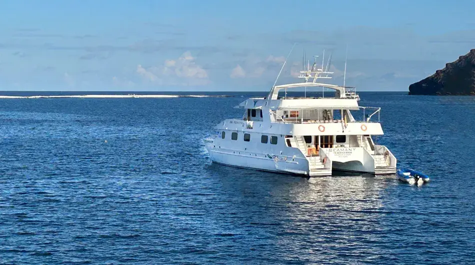 Seaman Journey ship cruising the Galapagos Islands with sand bar in the background