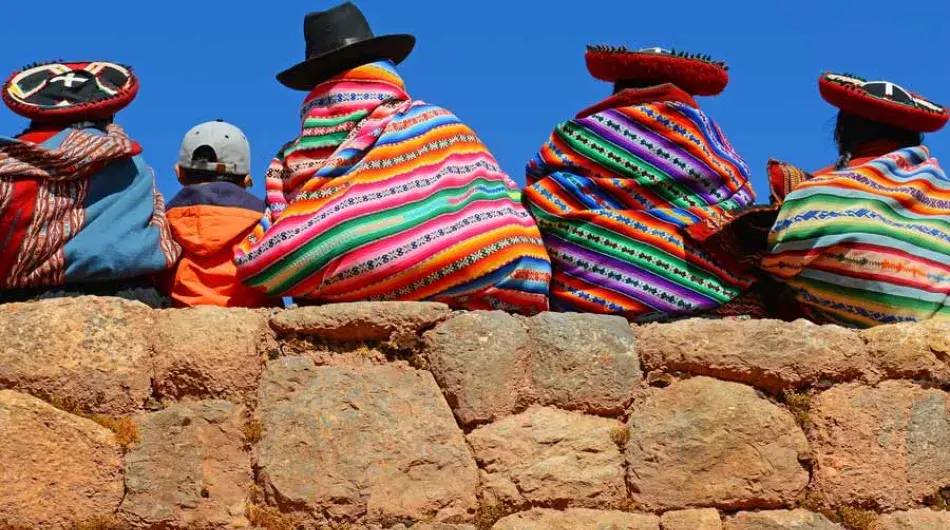Quechua people chatting on Inca wall 