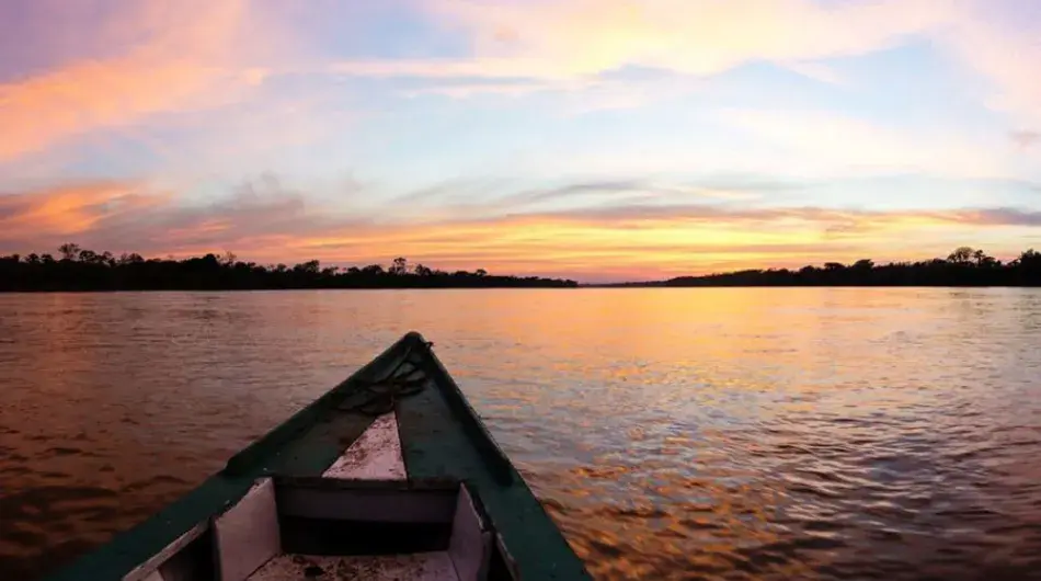 Peruvian Amazon sunset with skiff in the foreground