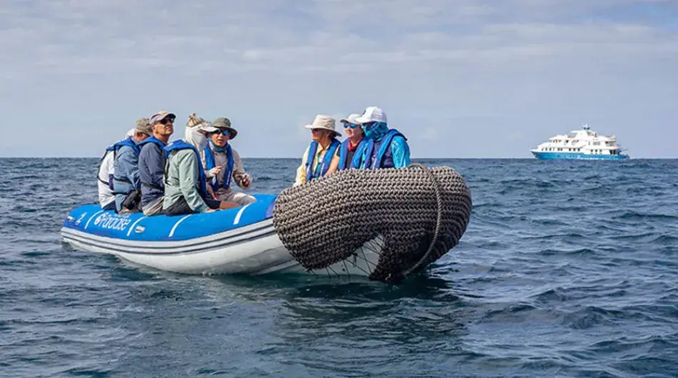 Group of people getting transferred by panga to the Galapagos Islands shore