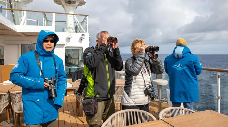 Passengers looking for wildlife on deck