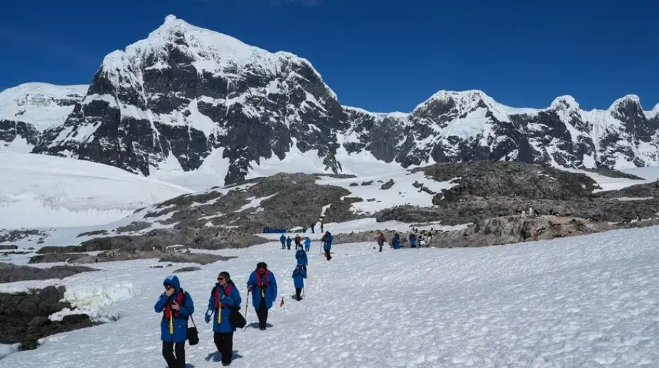 Passengers going for a walk in single file heading in land 