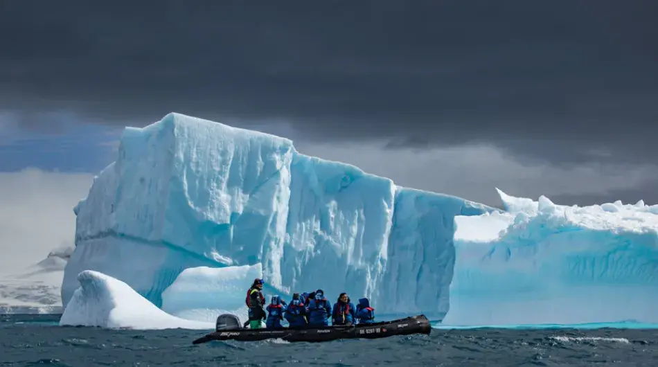 Zodiac in front of an iceberg