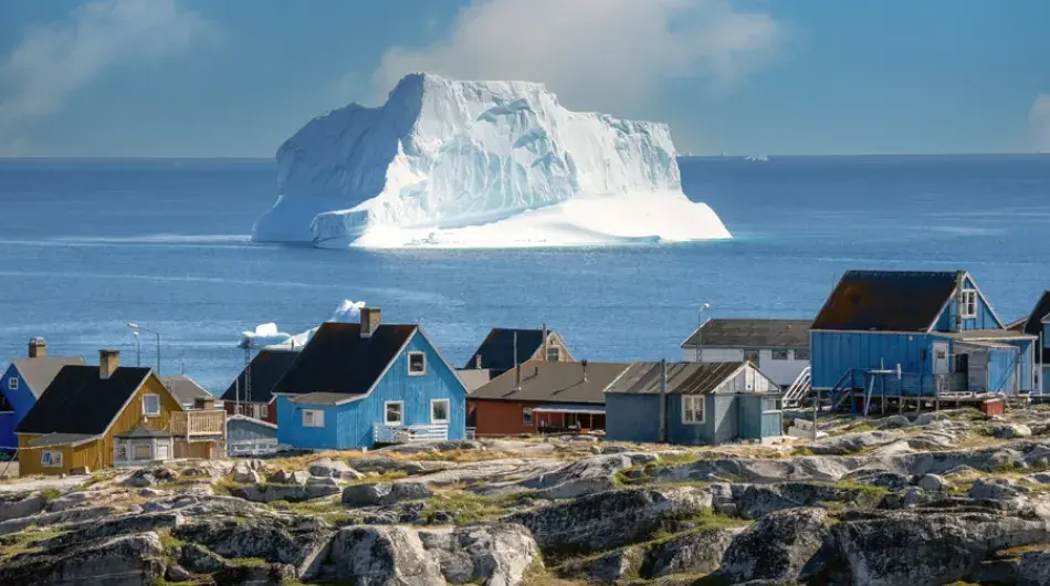 Qeqertarsuaq panorama with huge iceberg in background