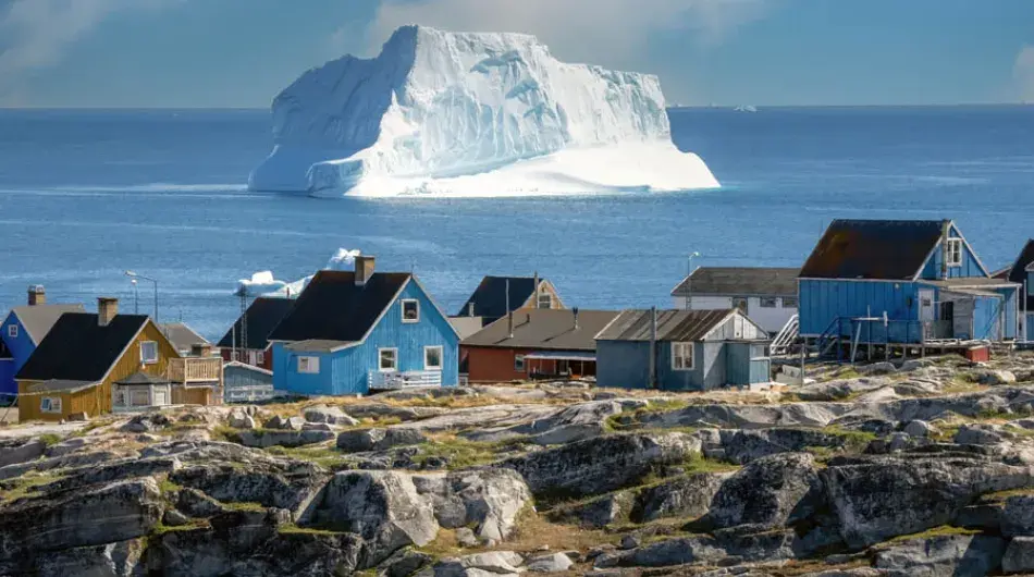 Qeqertarsuaq town with a large iceberg in the background