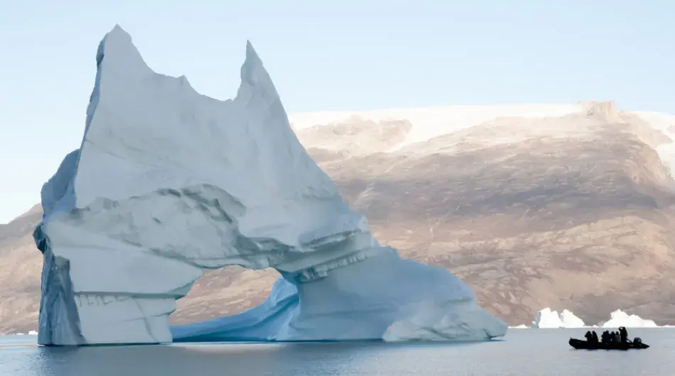Large arch Iceberg with a zodiac near by