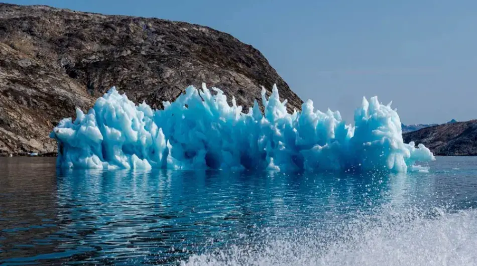 Sermilik fjord with blue iceberg
