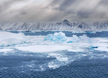Aerial view of icebergs in the Weddell Sea and snowy mountains of the Antarctic continent) 